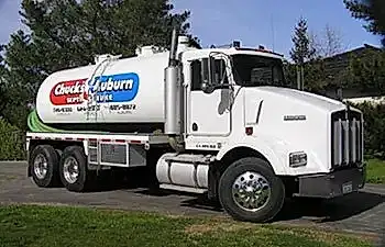 Photo of a white septic truck with a large logo on the side.
